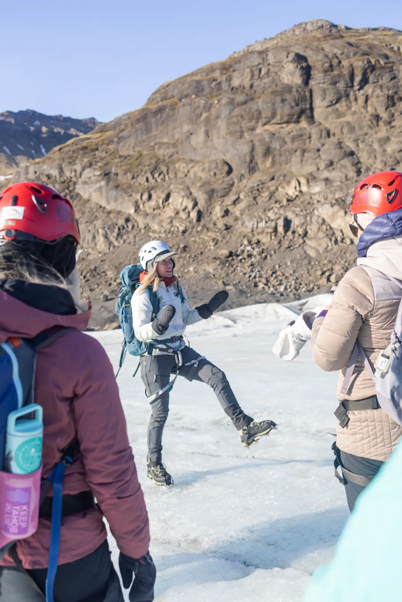 Women in helmets hiking on snow