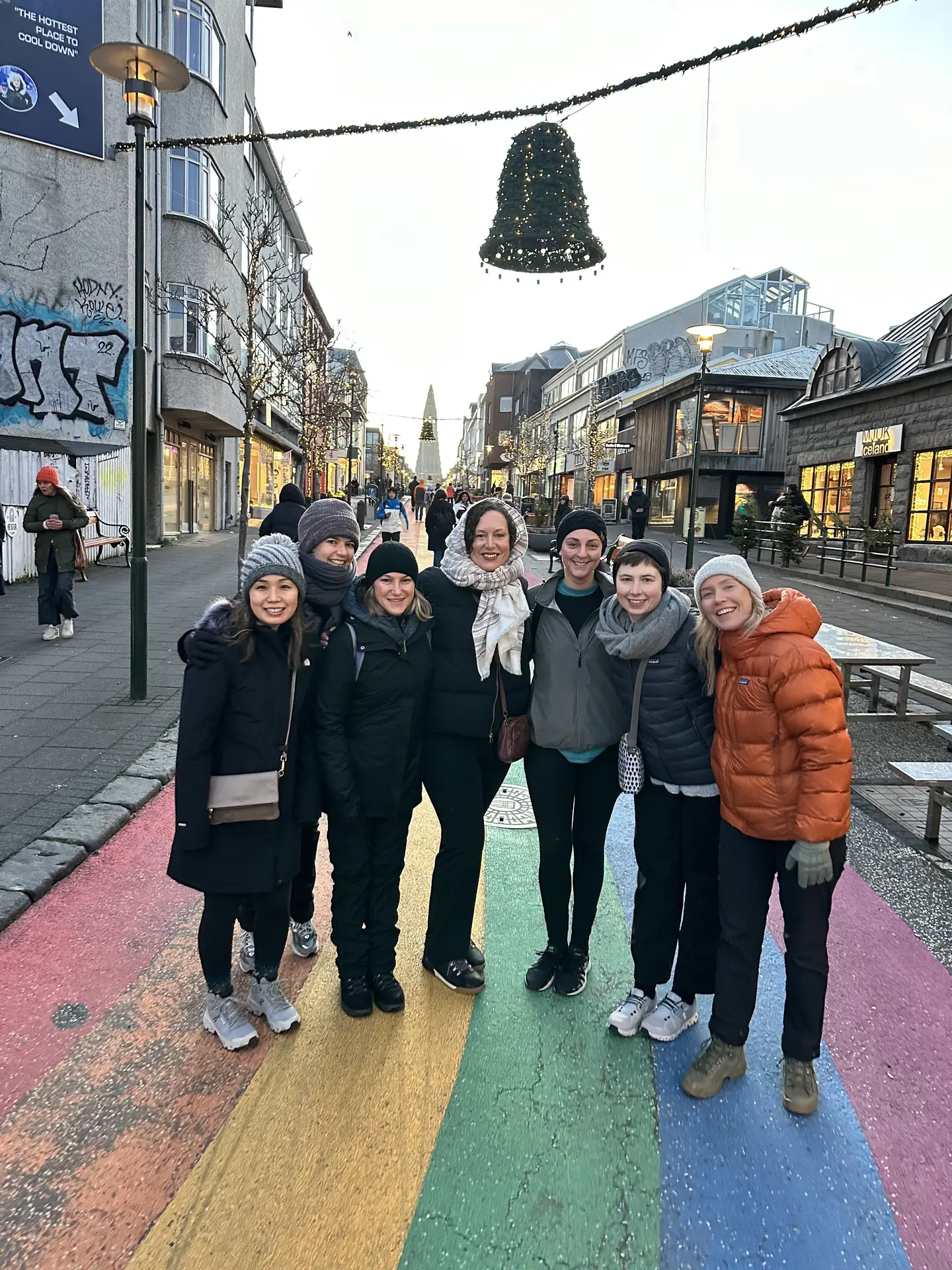 Group of women on a rainbow-painted street in winter