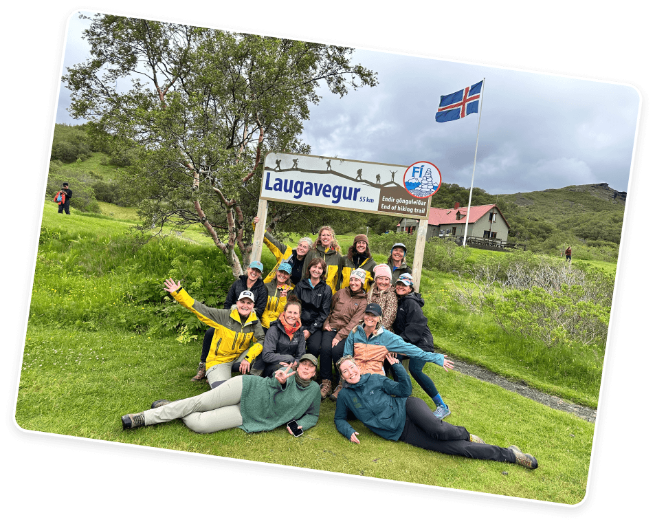 Group of hikers relaxing by the Laugavegur trail sign