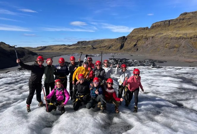 Group in helmets and crampons on a glacier