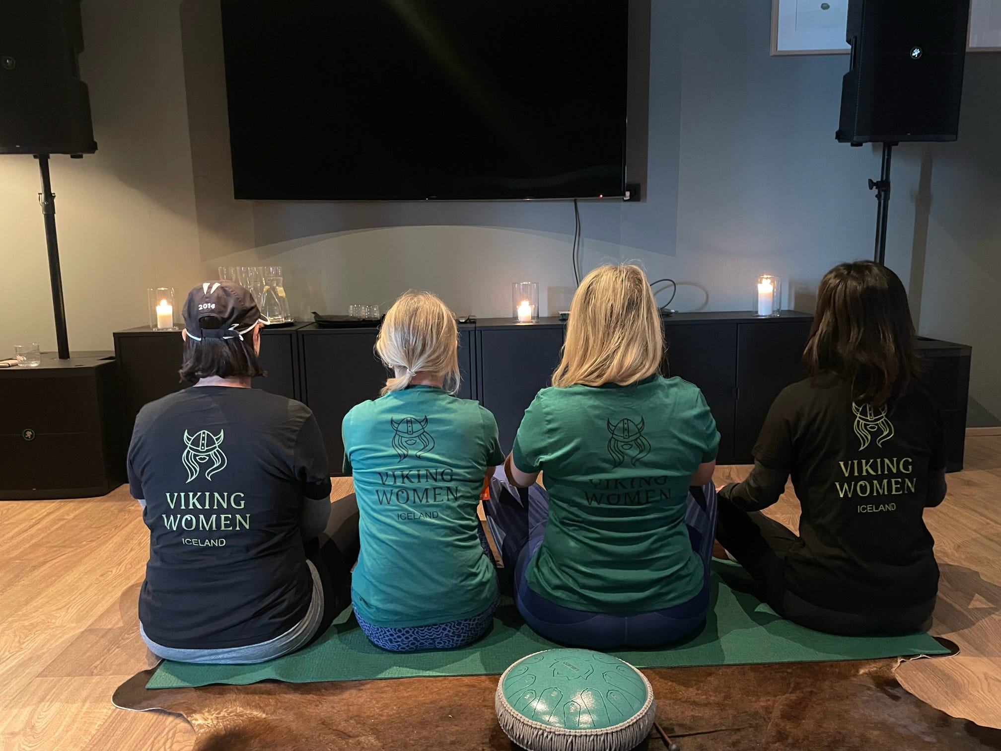 Four women in Viking Women shirts sitting on yoga mats