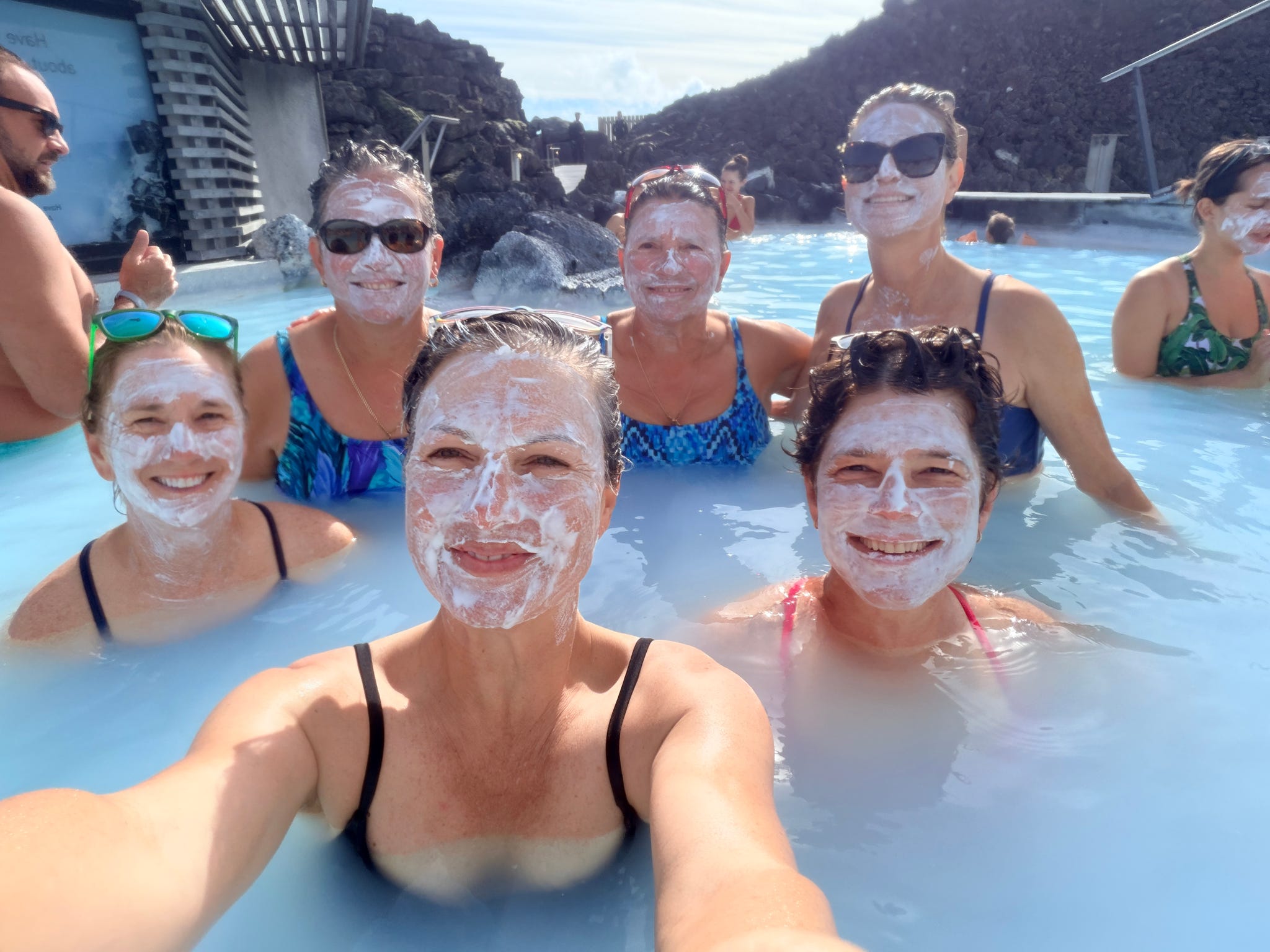 Women with face masks relaxing in a geothermal lagoon