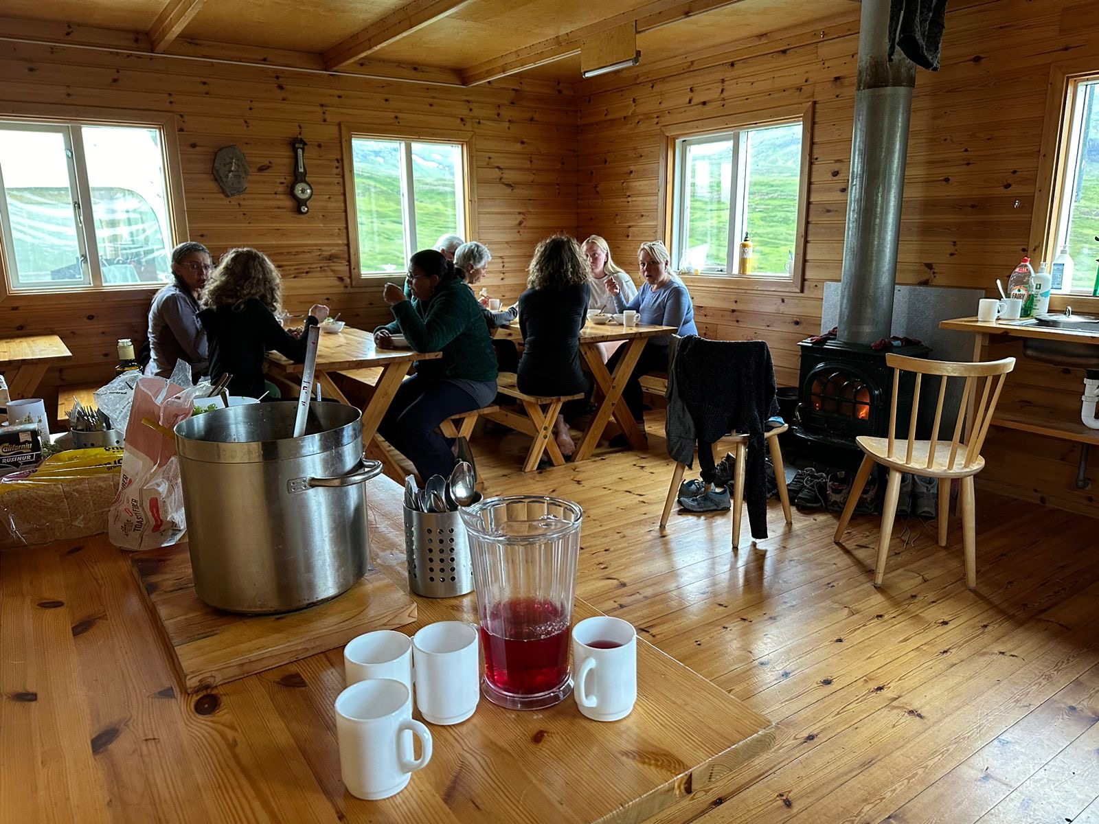Hikers relaxing in a wooden mountain hut kitchen