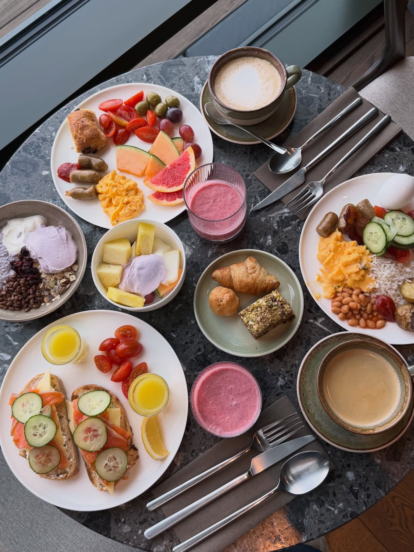Breakfast plates with fruit, pastries and coffee