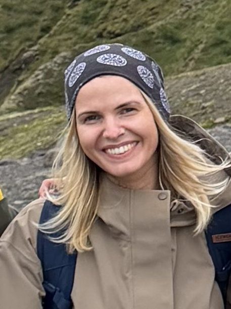 Smiling woman with long blonde hair in a patterned headband