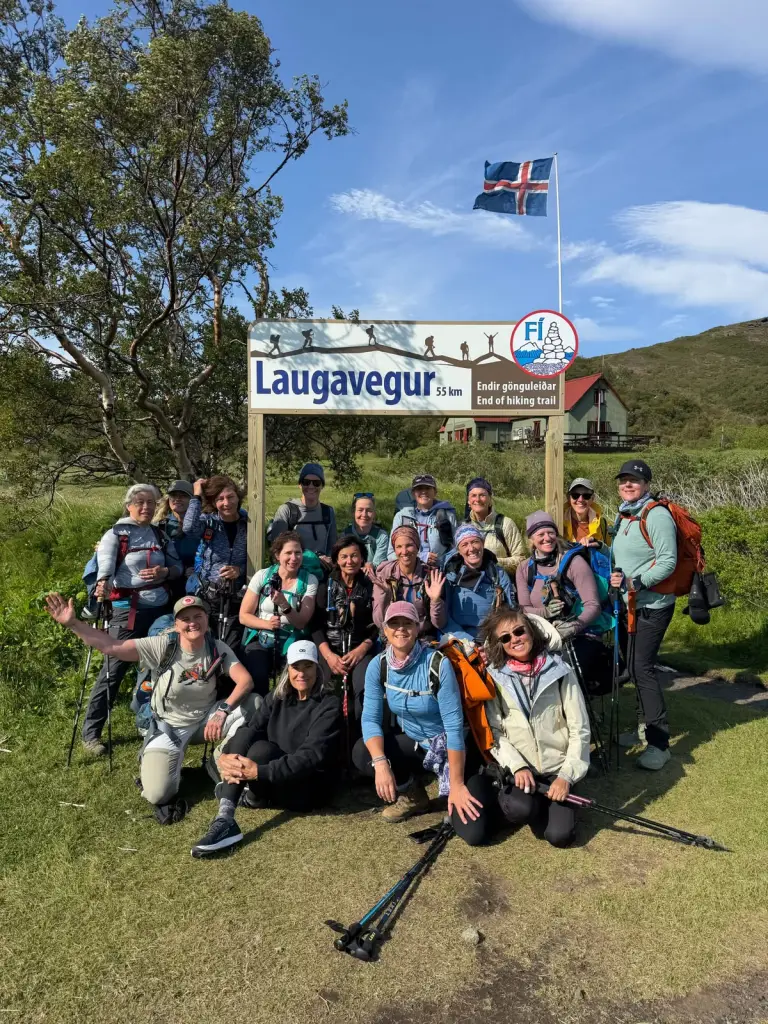 Group of hikers posing by the Laugavegur trail sign