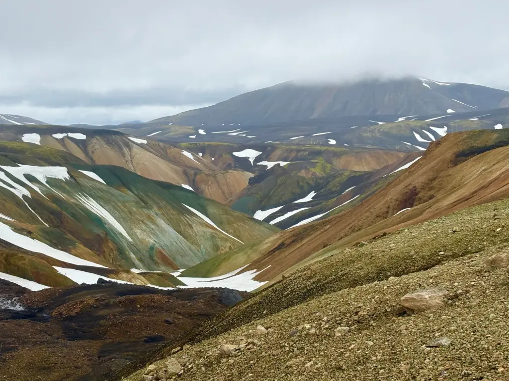Colorful rhyolite mountains with patches of snow