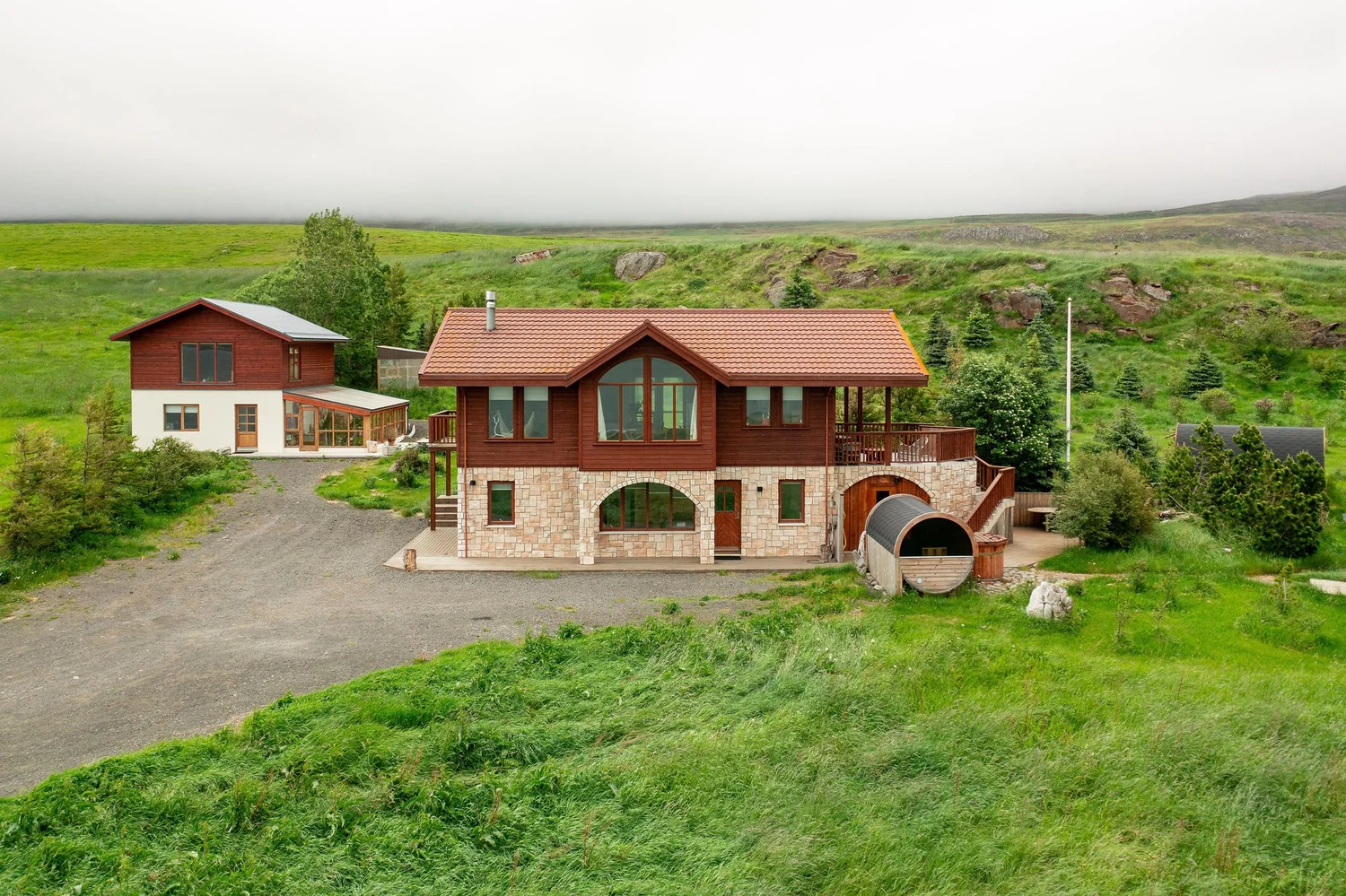 Helgafell retreat house and cabins on green hills in North Iceland