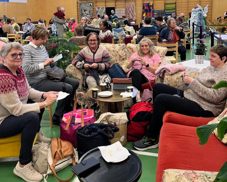 Women knitting together at a wool festival